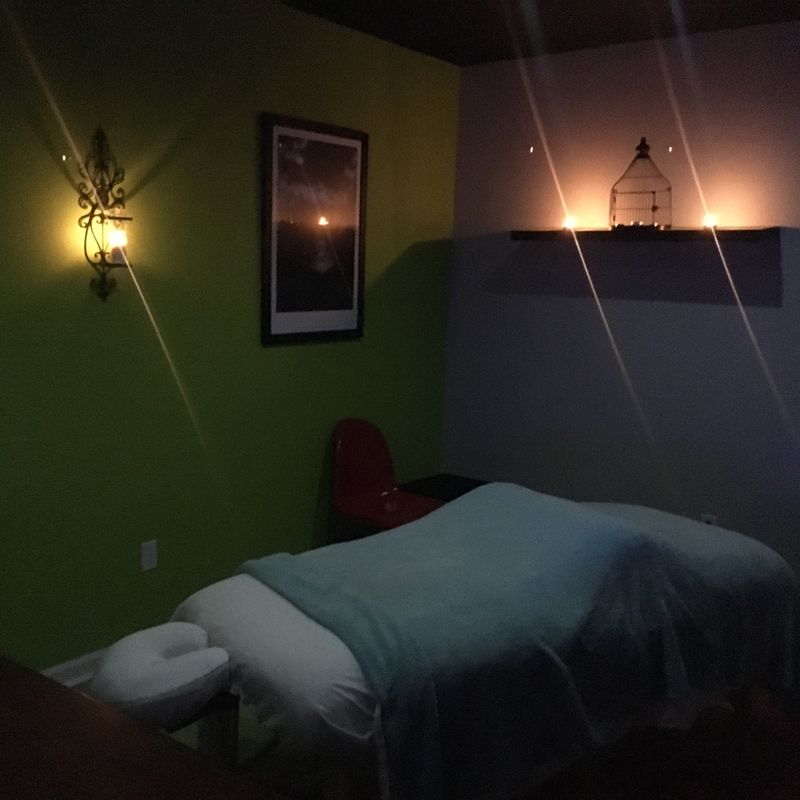 Candle-lit massage room with a massage table