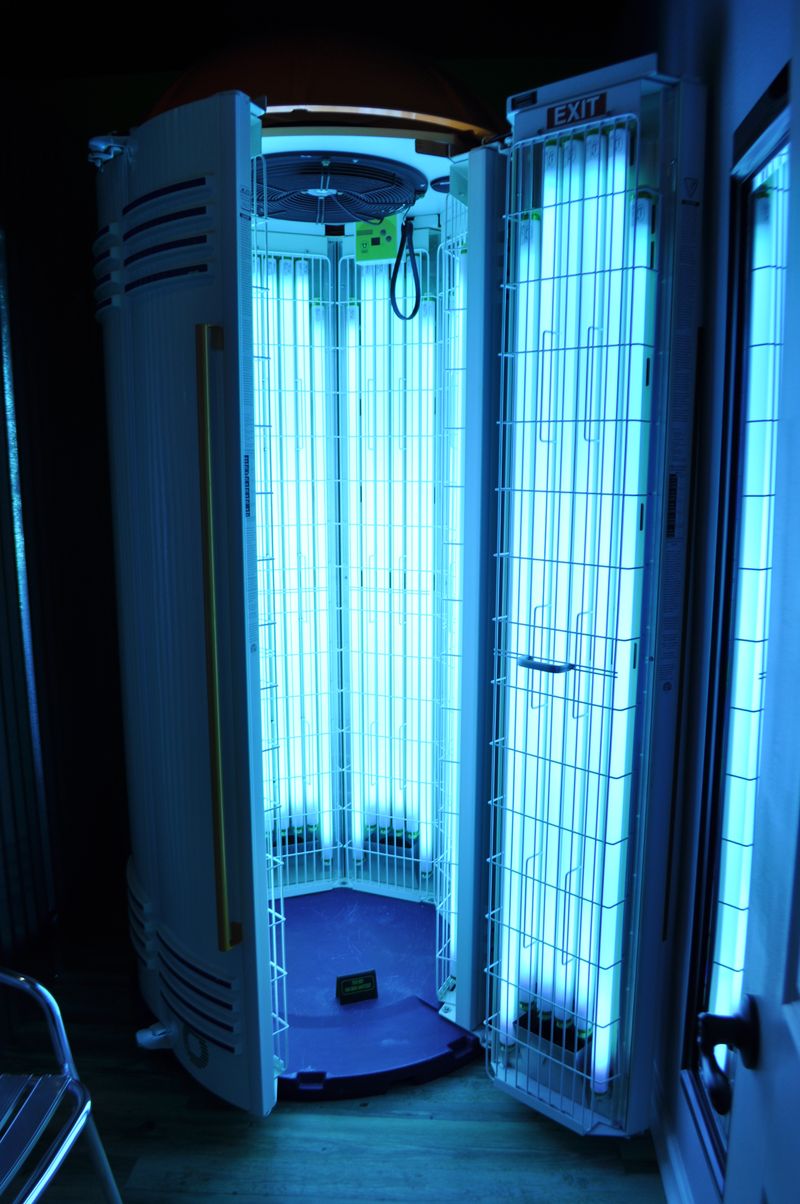 Stand-up tanning booth with blue lights
